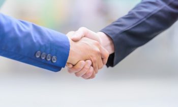 businessmen-making-handshake-blurred-background-business-partnership-concept_29505-179